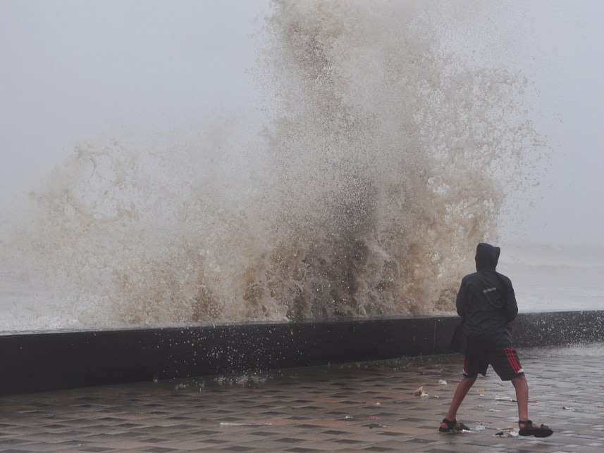 Mumbai, India - 22 June 2015:People enjoying the high tide at Worli seaface in Mumbai, India, on Monday, June 22, 2015. (Photo by Aloise Tiers/ Hindustan Times)
