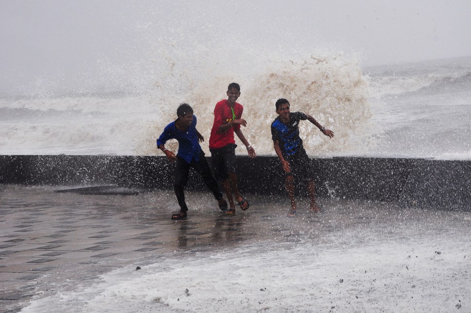 Mumbai, India - 22 June 2015: People enjoying the high tide at Worli seaface in Mumbai, India, on Monday, June 22, 2015. (Photo by Aloise Tiers/ Hindustan Times)